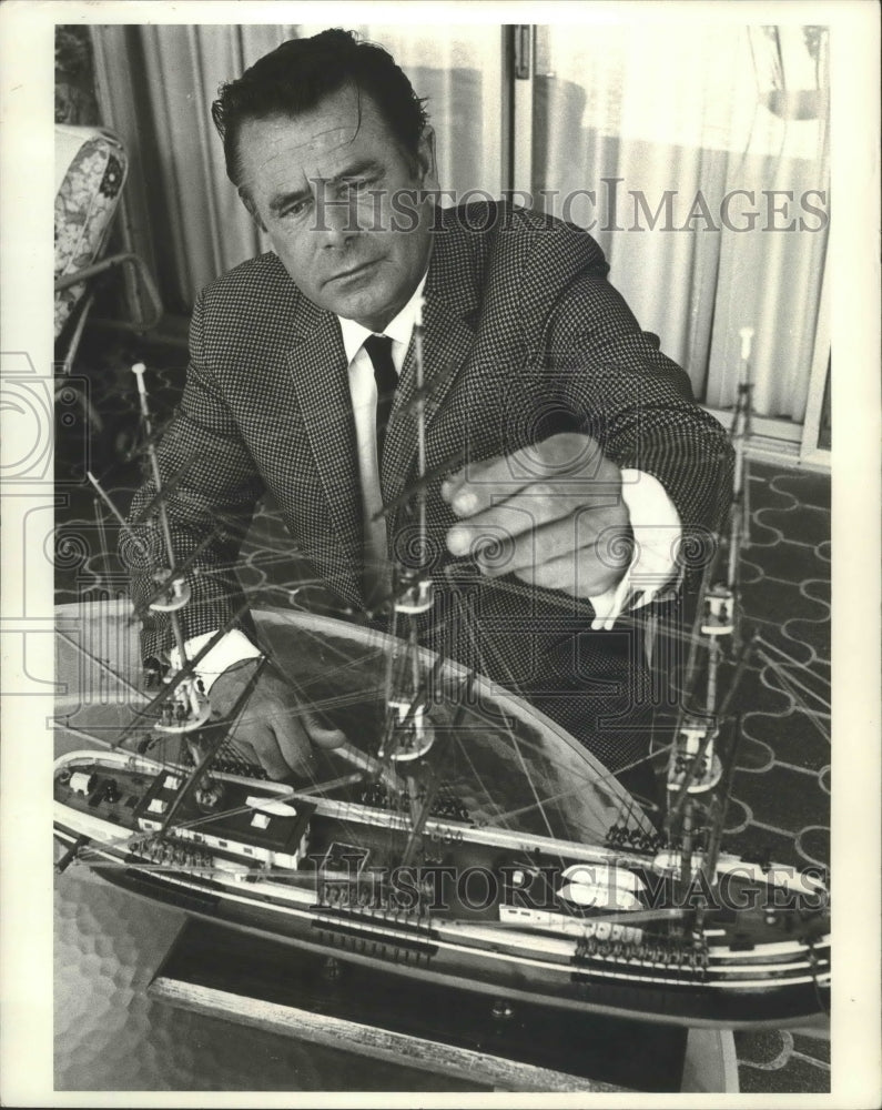 1971, Actor Glenn Ford with a model ship in his home - Historic Images