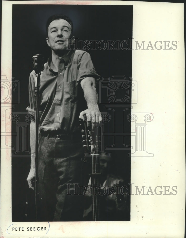 1969, Lanky Pete Seeger works his folk magic on a concert audience - Historic Images