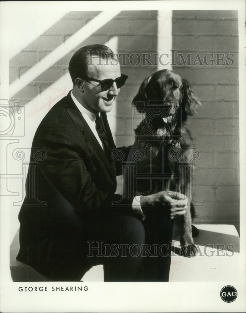 1970, George Shearing, Pianist, arranger, and composer with a dog - Historic Images