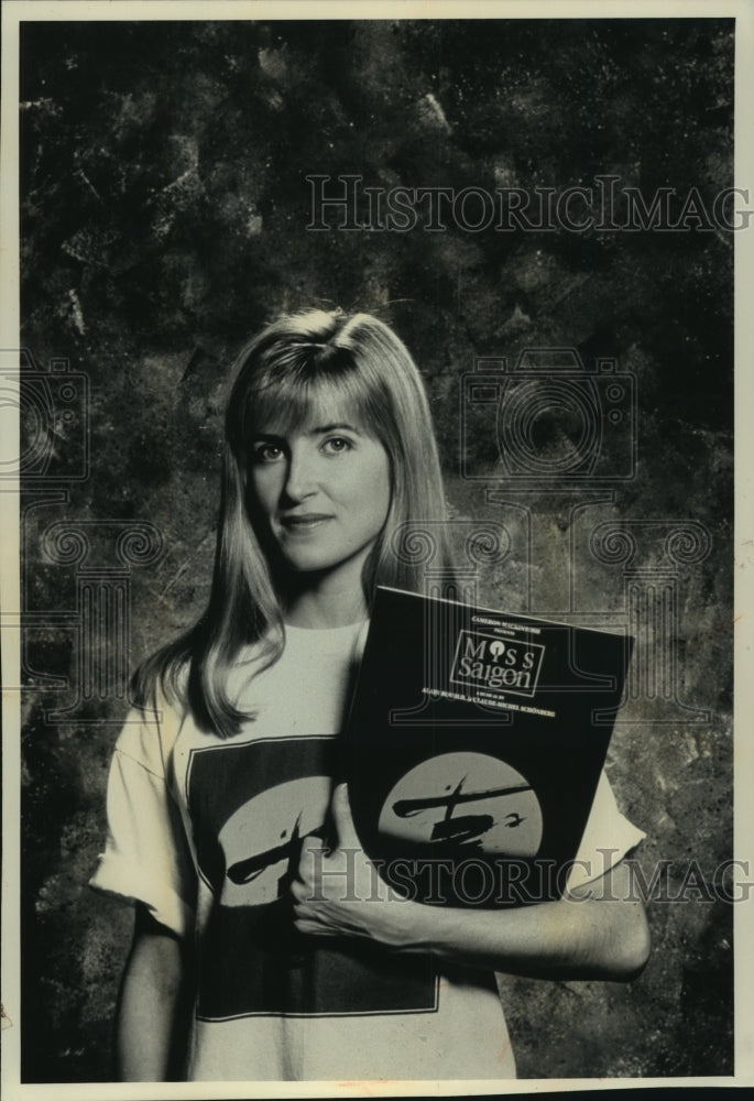 1991, Model shows off &quot;Miss Saigon&quot; tea shirt from Broadway play. - Historic Images