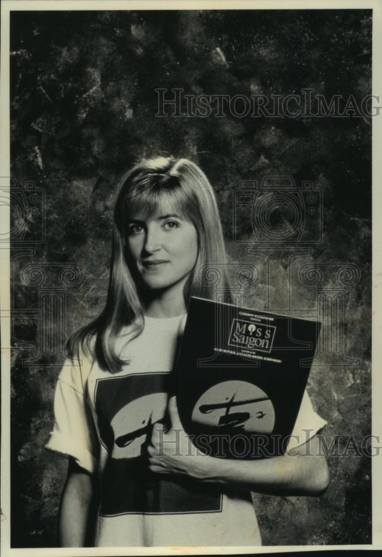 1991, Model shows off "Miss Saigon" tea shirt from Broadway play. - Historic Images