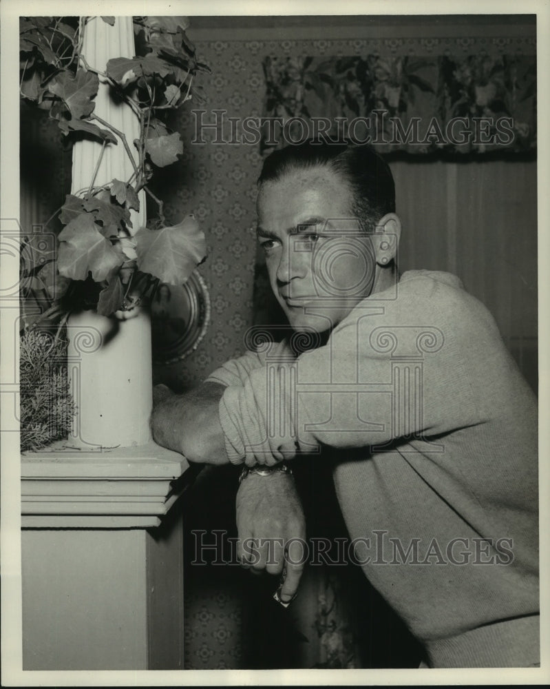 1957, Man leans against post - mjp39366 - Historic Images