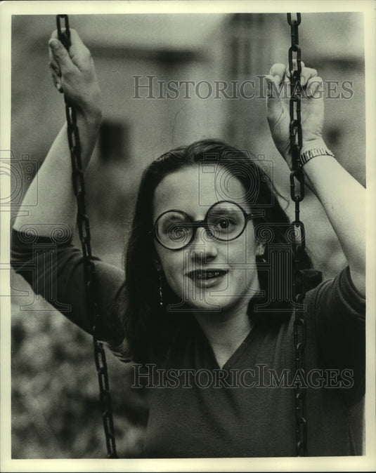1975 Actress Devon Scott on swing wearing glasses in "We'll Get By" - Historic Images