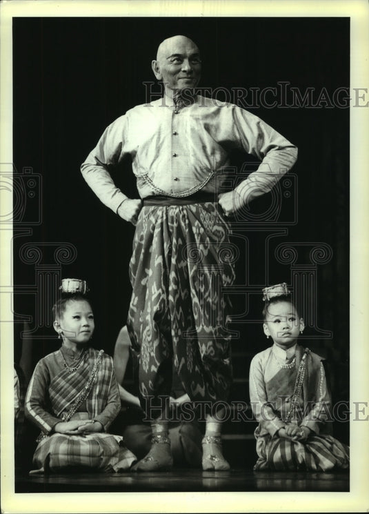 1985, Yul Brynner, 64, rehearses with children in "The King And I" - Historic Images