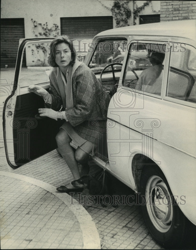 1963, Actress Ingrid Bergman stumbles out of a small car in Rome - Historic Images