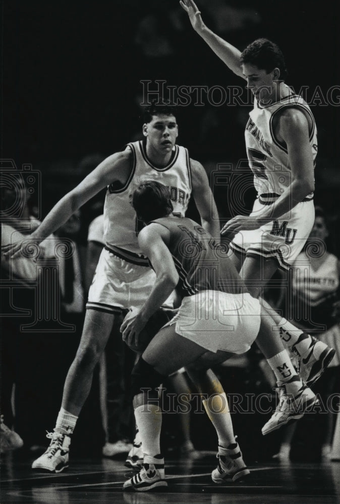 1989 Basketball players Joe Nethen, Mark Anglavar block opponent - Historic Images