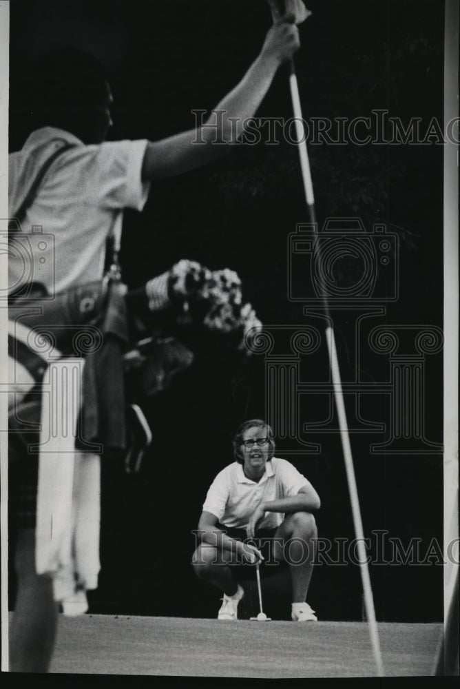1966 Golfer Kathleen Curran lines up a putt on the 19th hole - Historic Images