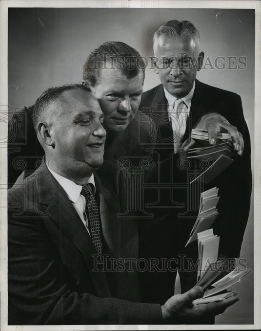 1958 Herman Kluge & company with football season tickets - Historic Images