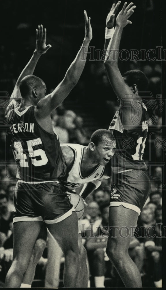 1966 Bucks&#39; Terry Cummings sneaks a peek between Pacers players - Historic Images