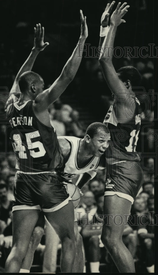 1966 Bucks' Terry Cummings sneaks a peek between Pacers players - Historic Images