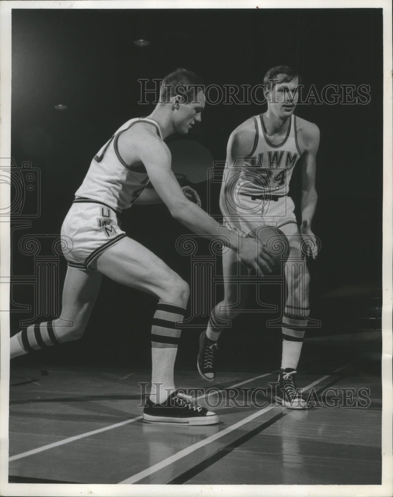 1969 Center Barry Umbs (R) and guard Terry Fredenberg dribbles ball. - Historic Images