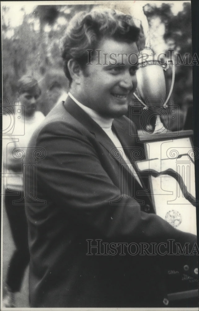 Press Photo Professional golfer Ray Floyd carrying a large trophy and smile.- Historic Images