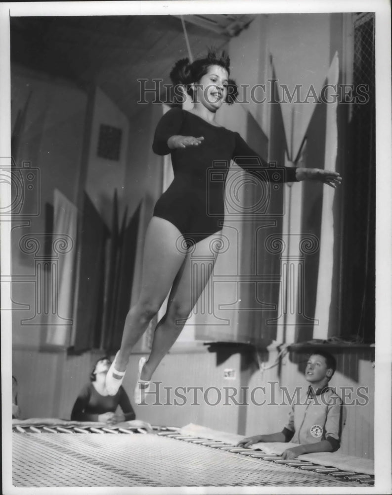 1965 Milwaukee Turners pupil, Nancy Schultz goes up off a trampoline - Historic Images