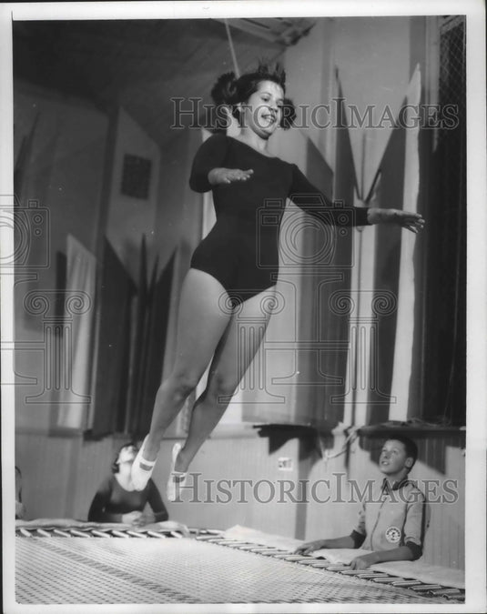 1965 Milwaukee Turners pupil, Nancy Schultz goes up off a trampoline - Historic Images