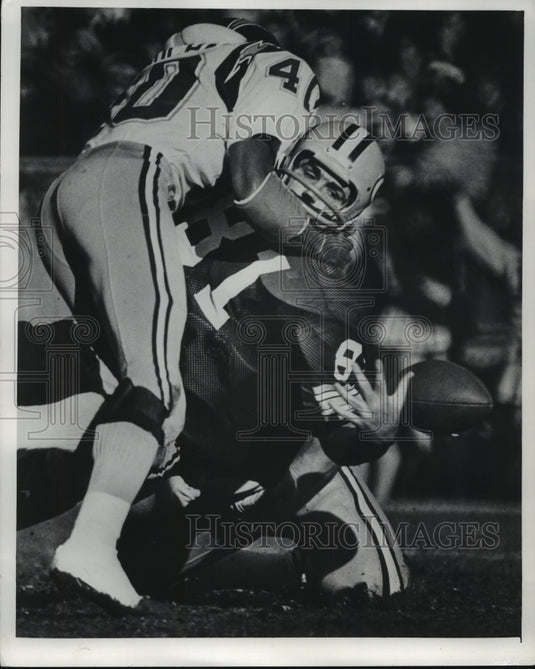 1974 Green Bay Packer player looses the ball as he is being tackled. - Historic Images