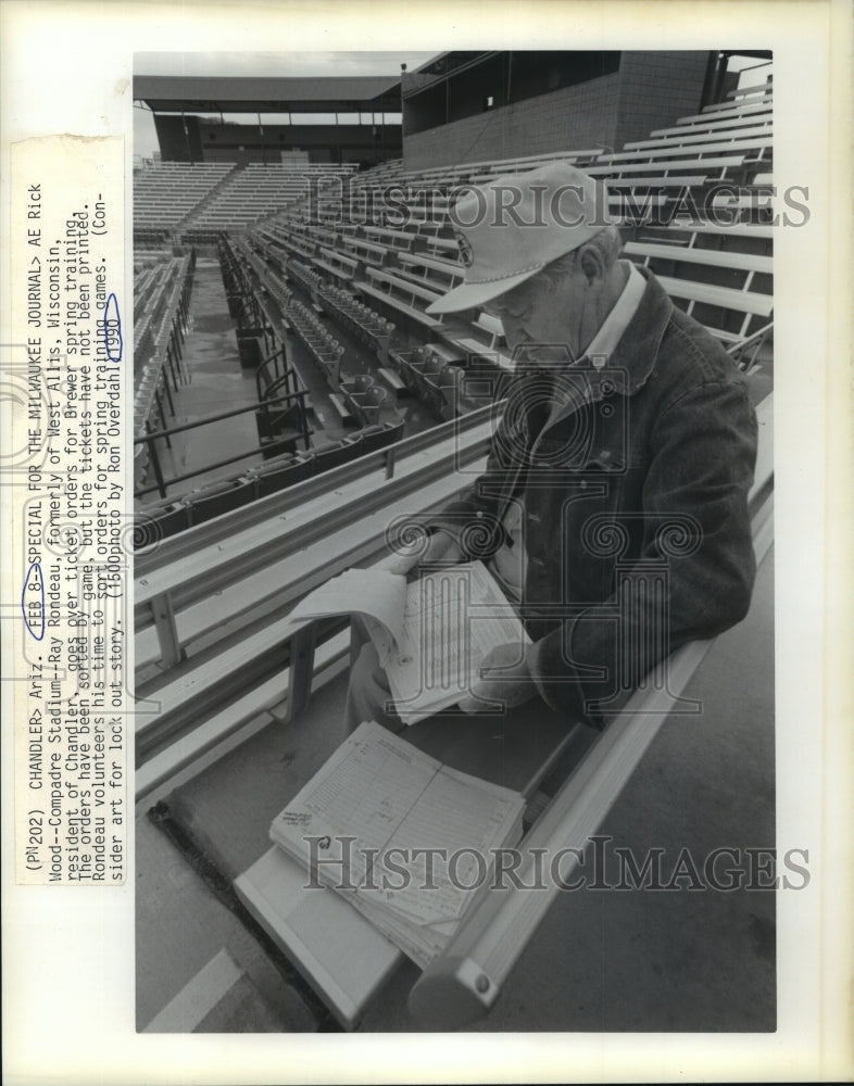 1990 Press Photo Ray Rondeau at Compadre Stadium sorts ticket orders, Arizona.- Historic Images