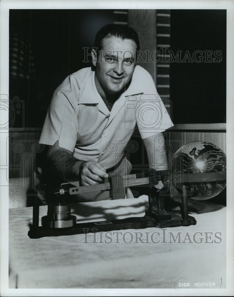 1967 Press Photo Professional bowler, Dick Hoover, weighing a bowling ball.- Historic Images