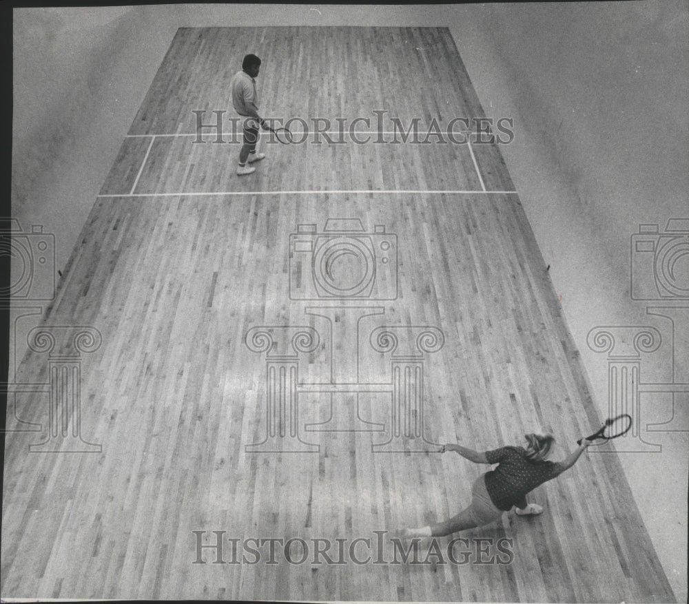 1976 Racquetball players reaching and running during a game - Historic Images