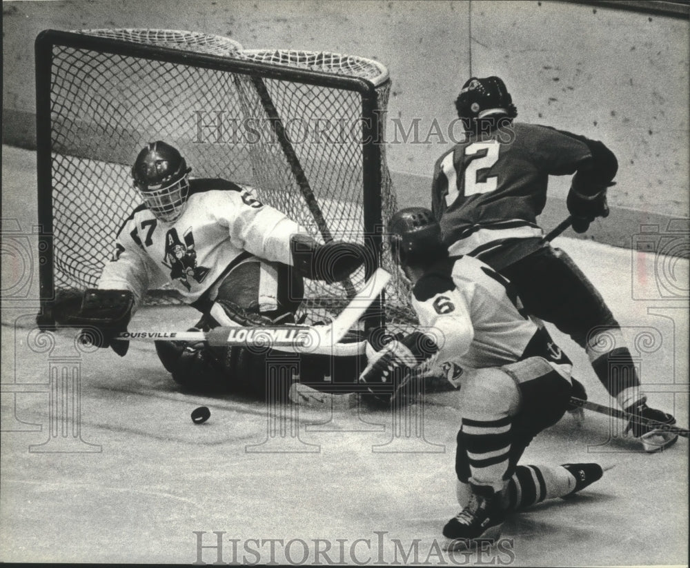 1983 Press Photo Admirals' Sirois blocks shot as Leef and McFarlane battle.- Historic Images