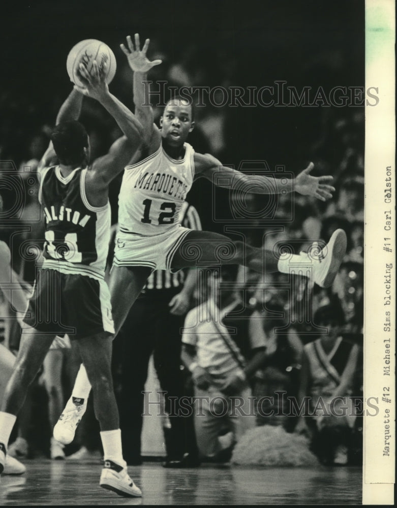 1984 Press Photo Marquette's Michael Sims defends shot against a foe. - Historic Images