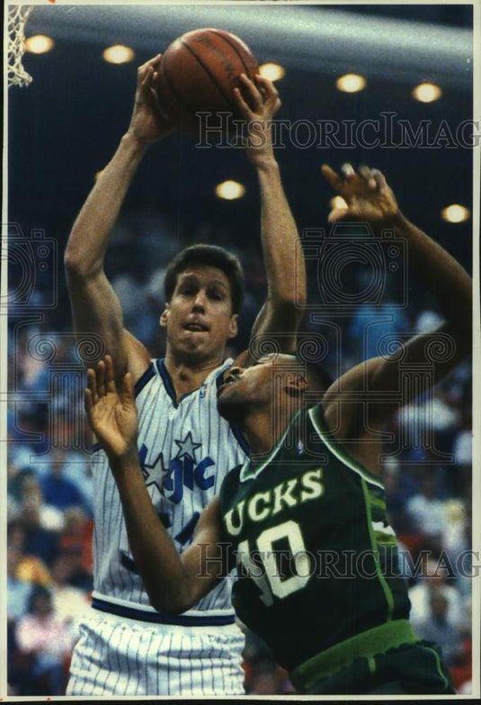 1993 Orlando Majic's Jeff Turner grabs one of his ten rebounds. - Historic Images