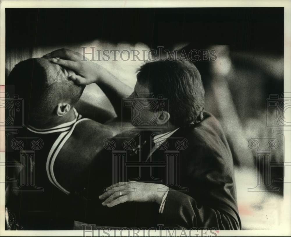 1994 Injured basketball forward Brian Kelley gets medical attention - Historic Images