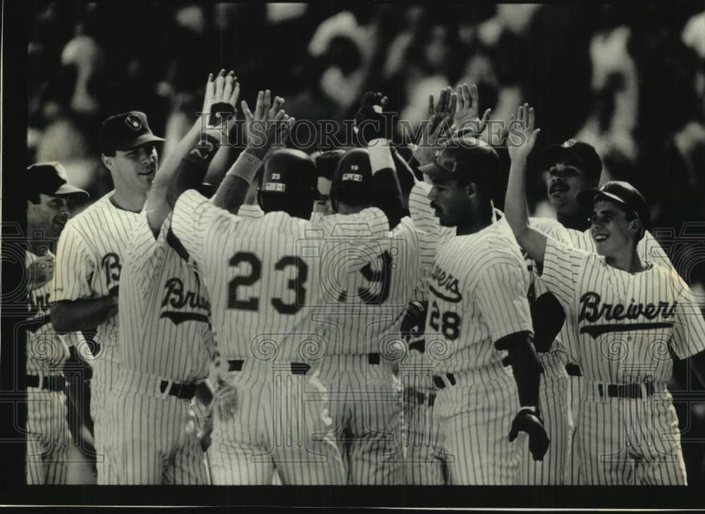 1991 Brewers' Greg Vaughn congratulated after 9th inning grand slam. - Historic Images