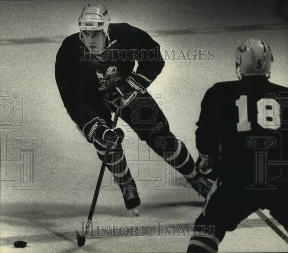 1992 Admirals hockey player Steve Tuttle with the puck - Historic Images