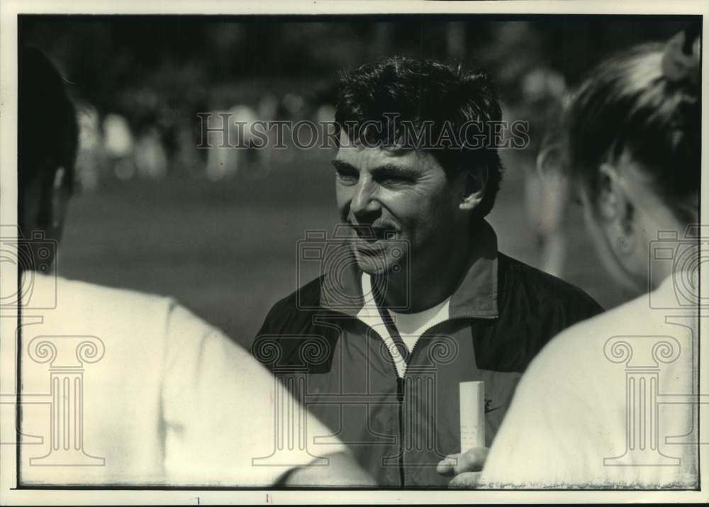 1992 Peter Tegen UW track coach giving advice to runners, Wisconsin. - Historic Images