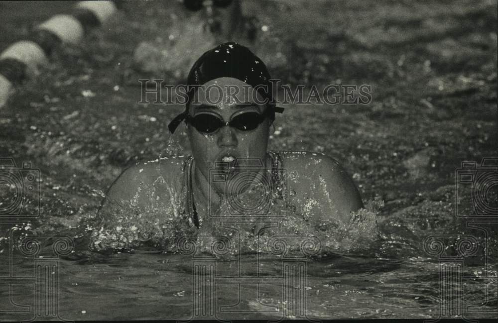 1992 Waukesha High School's Jennifer Stair practicing breast stroke. - Historic Images