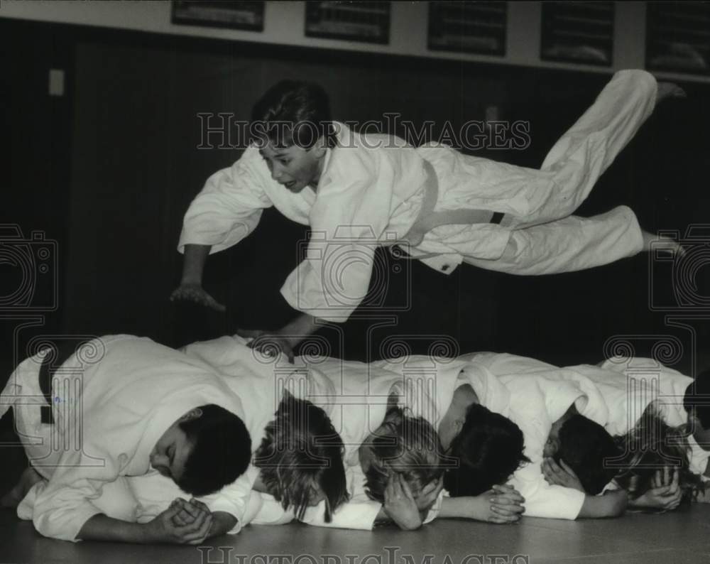 1994 Adam Nickel attempts jump over classmates, Germantown Judo Club - Historic Images