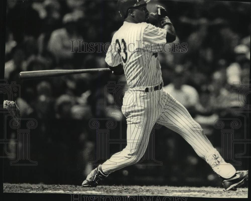 1992 Brewer outfielder Greg Vaughn swings hard driving a long ball. - Historic Images