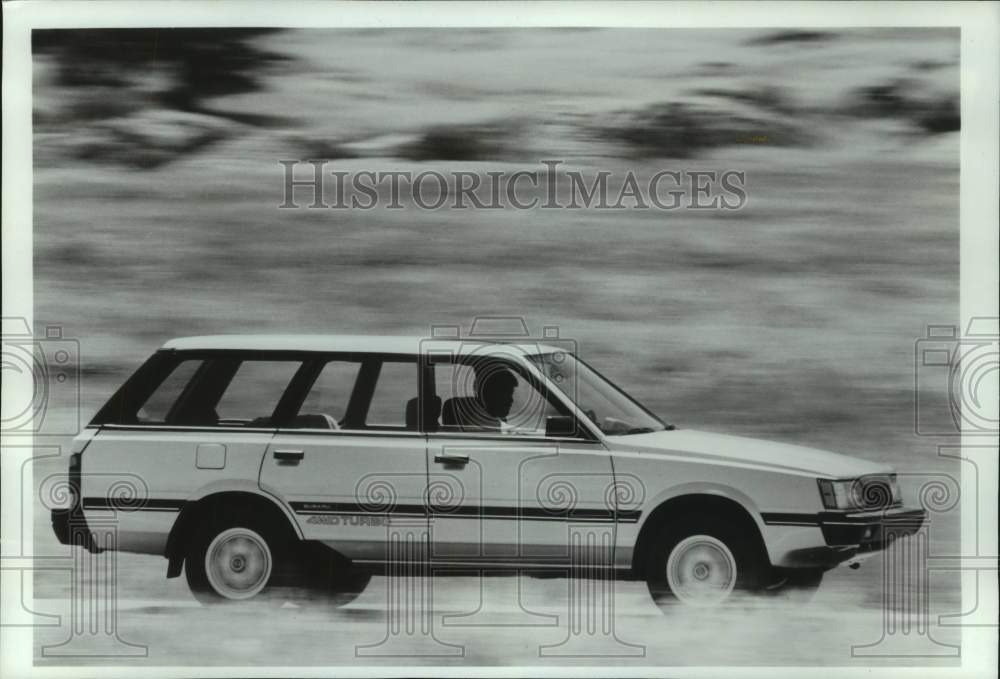 1986 Press Photo Man driving Subaru 4WD Turbo station wagon - mjt19549 - Historic Images