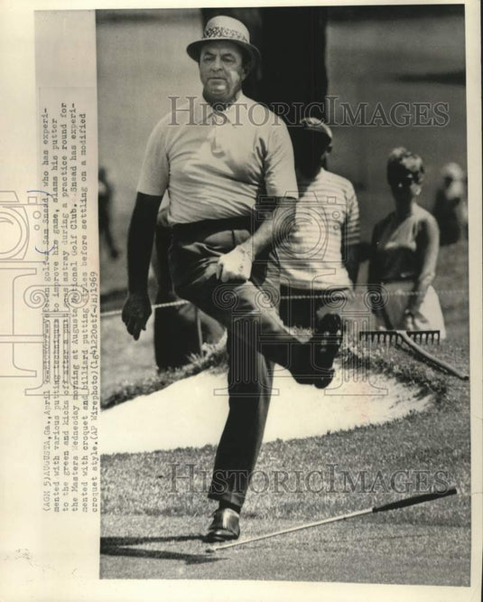 1969 Sam Snead kicks off after missing putt in practice at Augusta. - Historic Images