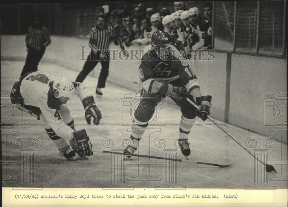 1984 Press Photo Admiral&#39;s Randy Boyd tries to steal the puck from Jim Aldred.- Historic Images