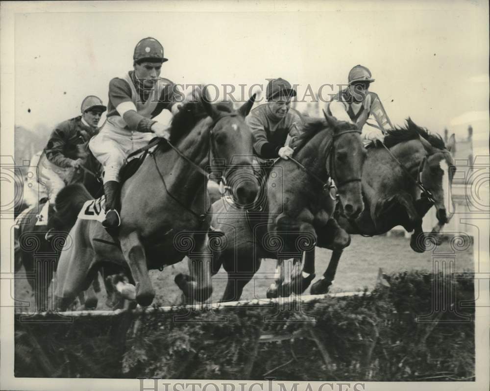 Three thoroughbreds sail over the first barrier at Kempton Park. - Historic Images