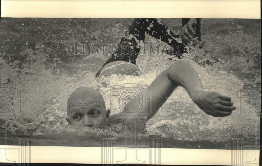 1987 Press Photo A competitor in the swimming portion churned the water. - Historic Images