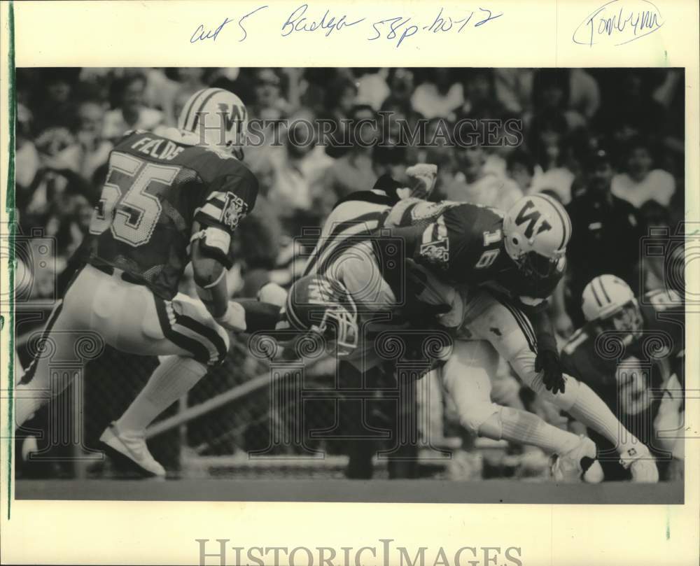 1985 Press Photo Wisconsin Badger&#39;s Eric Sydnor tackled Virgil Gern of NIU.- Historic Images