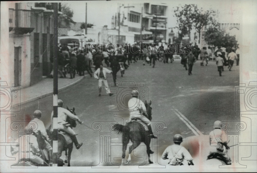 1981 Mounted Police pursue rioting students in Quito's Bolivar Plaza - Historic Images