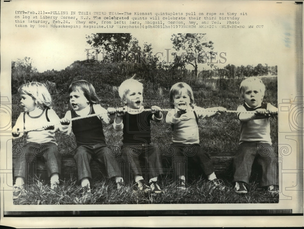 1973 Press Photo Kienast quintuplets pull on a rope as they sit on a log- Historic Images
