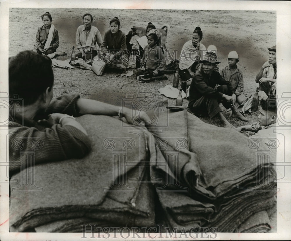 1961 Press Photo Laotian villagers wait for blanket from the U.S. - Historic Images