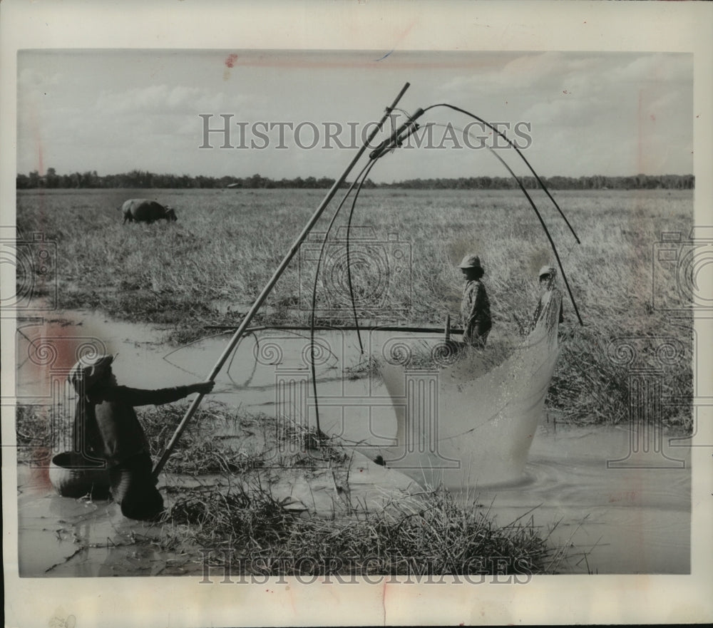1963 Fisherman Uses Looping Nets To Catch Fish In Laos Riverlands-Historic Images