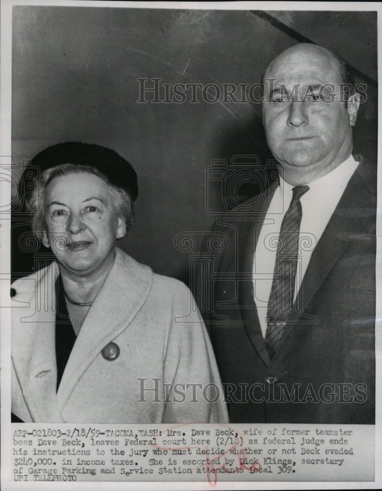 1959 Mrs Dave Beck is escorted out of Federal Court by Dick Klinge - Historic Images