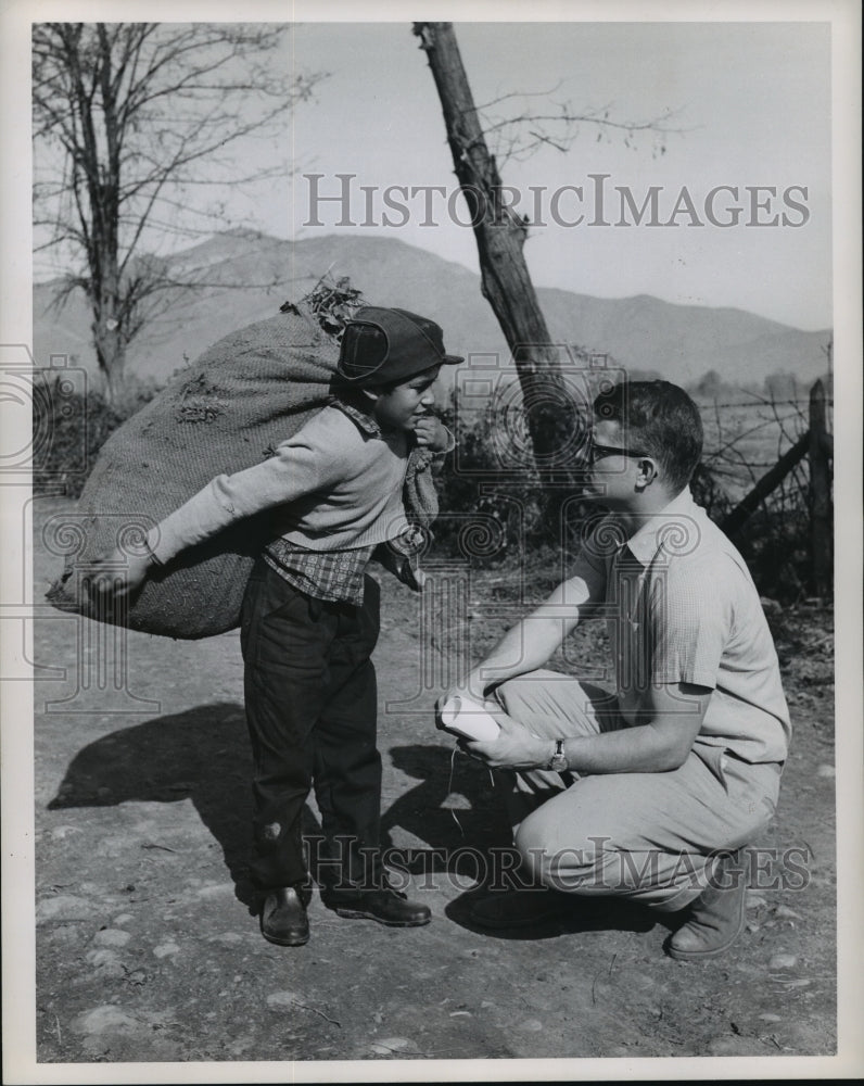 1964 Chilean farm boy pauses to chat with Marion R. Brown - Historic Images