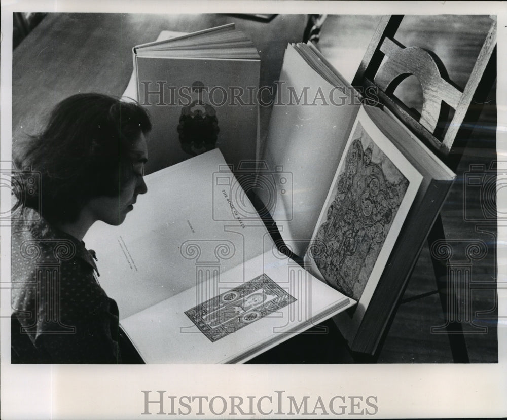 1961 Press Miss Sherry Heederick examines a facsimile of the Book of Kells-Historic Images