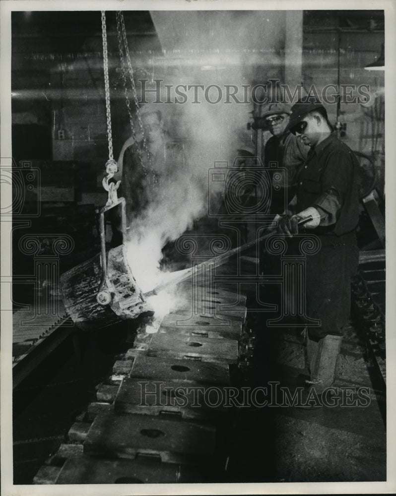 1957 Press Photo Workers pour iron into molds at a Canadian factory. - mjx19329-Historic Images