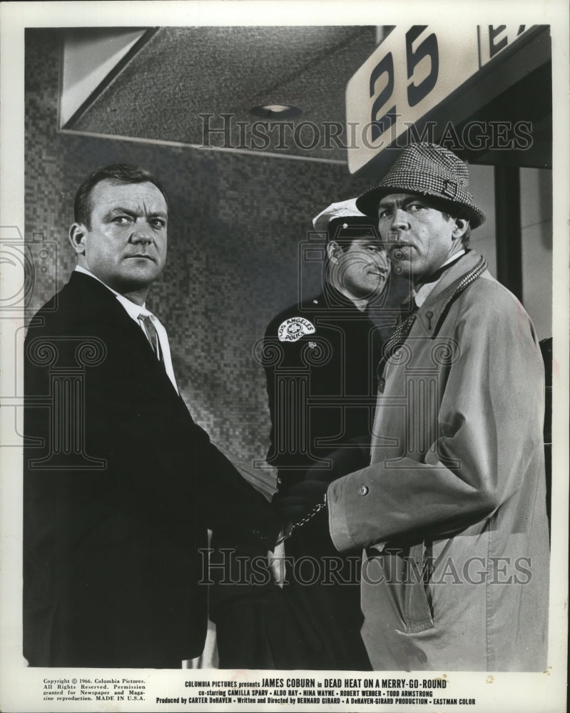 1966 Press Photo James Coburn and Aldo Ray in "Dead Heat on a Merry-Go-Round." - Historic Images