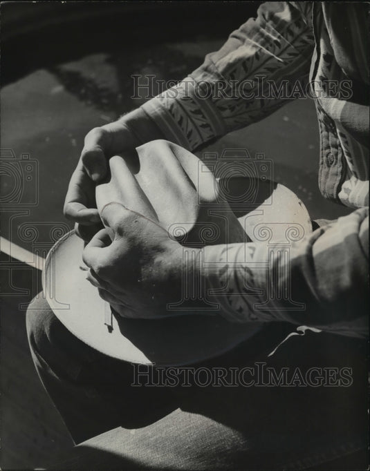 1952 Press Photo Unnamed Cowboy Modifying Hat With Curves and Bends - mjx25490-Historic Images