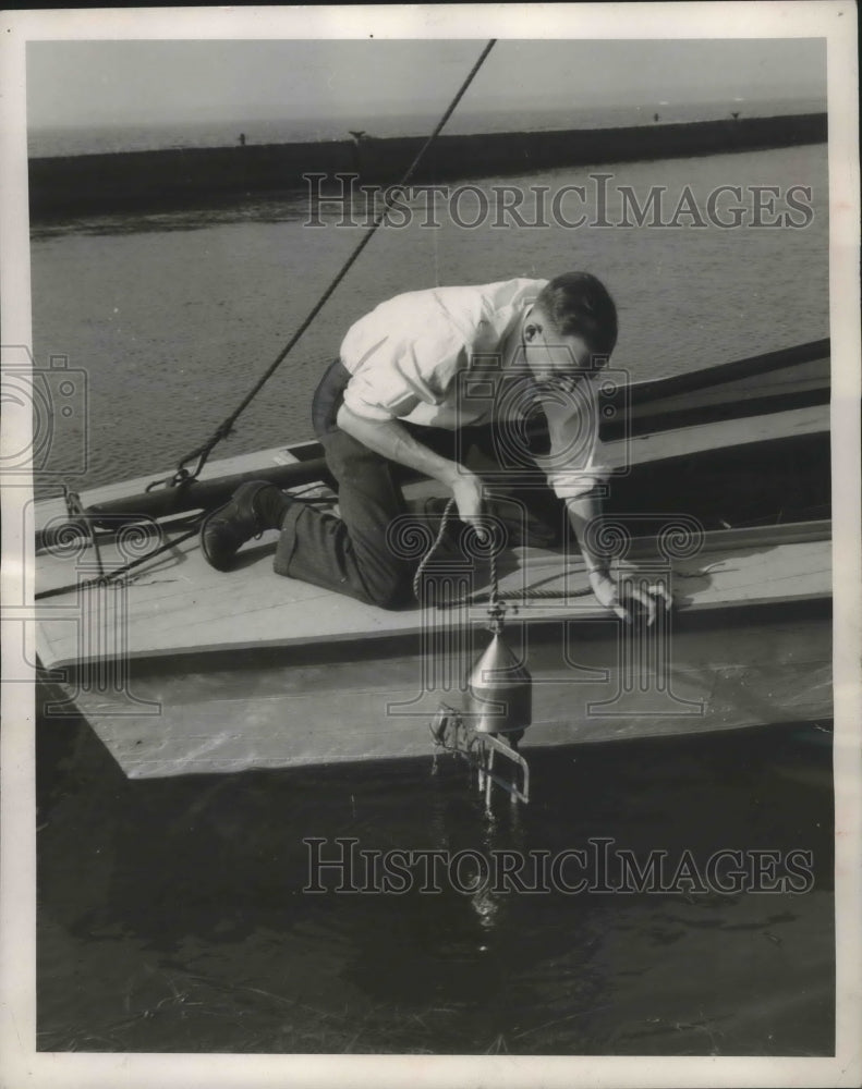 1957 Press Photo Engineer Emerson Tempas Pulls Up Magnet - mjx36690-Historic Images