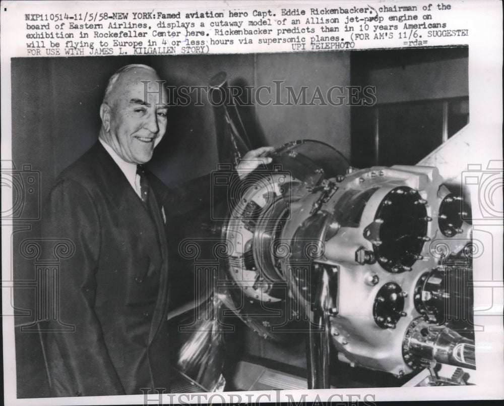 1958 Press Photo Captain Eddie Rickenbacker with jet-prop engine model, New York-Historic Images